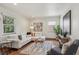 Open living room featuring large windows and modern décor at 1109 Jersey St, Denver, CO 80220