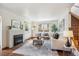 Bright living room with fireplace, large windows, and hardwood floors at 1109 Jersey St, Denver, CO 80220