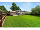 Spacious backyard with a deck, patio area, lush lawn, and privacy fencing, perfect for outdoor gatherings and relaxation at 9196 W Maplewood Ave, Littleton, CO 80123
