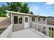 Spacious backyard deck with white railings, leading to a backyard, and attached to the house's upper level at 9196 W Maplewood Ave, Littleton, CO 80123
