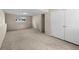 Carpeted basement featuring built-in storage and a closet at 9196 W Maplewood Ave, Littleton, CO 80123