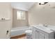 Bathroom boasting new fixtures, a tub/shower, and modern vanity at 9196 W Maplewood Ave, Littleton, CO 80123