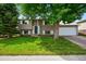 Charming two-story home with a well-maintained lawn and mature tree in a desirable neighborhood at 9196 W Maplewood Ave, Littleton, CO 80123