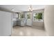 Bright kitchen with white cabinets, a window over the sink, and access to the deck at 9196 W Maplewood Ave, Littleton, CO 80123