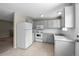 Functional kitchen with appliances, ample counter space, and subway tile backsplash at 9196 W Maplewood Ave, Littleton, CO 80123
