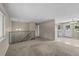 Open living area with staircase and view into kitchen at 9196 W Maplewood Ave, Littleton, CO 80123