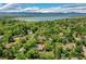 Aerial view of the property showing its location near a lake, and nestled among mature trees at 4701 Homestead St, Bow Mar, CO 80123