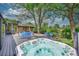 Relax in the back deck hot tub, with views of the backyard, patio furniture, and lush landscaping at 4701 Homestead St, Bow Mar, CO 80123