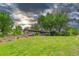 Expansive backyard with a lush lawn, mature trees, garden beds and an inviting outdoor space at 4701 Homestead St, Bow Mar, CO 80123