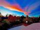 Beautiful backyard with a concrete pad, a basketball hoop, and a colorful autumn sky at dusk at 4701 Homestead St, Bow Mar, CO 80123