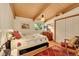 Comfortable bedroom featuring hardwood floors, a dresser, and a sunlit window at 4701 Homestead St, Bow Mar, CO 80123