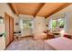 This bright bedroom includes two beds, wood floors, and large sunlit windows at 4701 Homestead St, Bow Mar, CO 80123