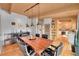 This dining room features wood floors, an oversized table, and backyard access at 4701 Homestead St, Bow Mar, CO 80123
