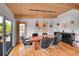Inviting dining room featuring hardwood floors, stylish lighting, and deck access at 4701 Homestead St, Bow Mar, CO 80123