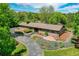 Ranch style home with gorgeous landscaping, trees, and driveway at 4701 Homestead St, Bow Mar, CO 80123
