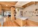 Bright kitchen featuring an island, custom cabinets, and lots of counter space at 4701 Homestead St, Bow Mar, CO 80123