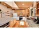 This kitchen has granite counters, wood cabinets, and stainless steel appliances at 4701 Homestead St, Bow Mar, CO 80123