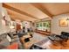 Bright living room with hardwood flooring, ample seating, and large windows at 4701 Homestead St, Bow Mar, CO 80123