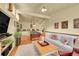 This spacious living room has hardwood floors, a pool table, and a comfortable sofa at 4701 Homestead St, Bow Mar, CO 80123