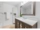 Elegant bathroom with a modern vanity, decorative mirror, and neutral color palette at 7068 E Briarwood Dr, Centennial, CO 80112