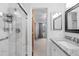 Bright bathroom with a shower, granite counters, and modern fixtures at 7068 E Briarwood Dr, Centennial, CO 80112