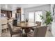 Dining area with a round wood table, seating for four, and wood-look tile floors at 7068 E Briarwood Dr, Centennial, CO 80112