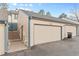 Exterior view of a two-car garage with a unit number above each door at 7068 E Briarwood Dr, Centennial, CO 80112