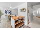 View from the kitchen of the dining area featuring a breakfast island and white walls at 7068 E Briarwood Dr, Centennial, CO 80112