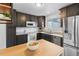 Updated kitchen featuring modern appliances, granite countertops, and dark wood cabinetry at 7068 E Briarwood Dr, Centennial, CO 80112