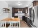 Updated kitchen featuring stainless steel appliances, a center island, and dark wood cabinetry at 7068 E Briarwood Dr, Centennial, CO 80112