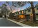 Street view of townhomes featuring brick and siding exteriors, with mature trees at 7068 E Briarwood Dr, Centennial, CO 80112