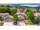 Aerial view of home featuring a well manicured lawn, mature trees, fountain, and two car garage at 16458 W Ellsworth Dr, Golden, CO 80401