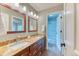 Bathroom with double vanity, granite counters, wood cabinets and access to a walk-in shower at 16458 W Ellsworth Dr, Golden, CO 80401
