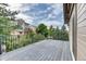 This deck features dark wood, metal railings, and views of other homes and foliage at 16458 W Ellsworth Dr, Golden, CO 80401