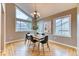 Dining room featuring many windows and a modern chandelier illuminating the table at 16458 W Ellsworth Dr, Golden, CO 80401
