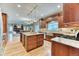 Open kitchen featuring custom cabinets, a granite counter-top island, and stainless steel appliances at 16458 W Ellsworth Dr, Golden, CO 80401