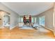 Spacious living room with hardwood floors, a fireplace, built-in shelving, and plenty of natural light at 16458 W Ellsworth Dr, Golden, CO 80401