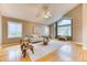 This living room features hardwood floors, a ceiling fan, and a large window at 16458 W Ellsworth Dr, Golden, CO 80401