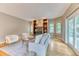 Bright living room with hardwood floors, a fireplace, built-in shelving, and a sliding glass door to the backyard at 16458 W Ellsworth Dr, Golden, CO 80401