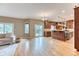 Open-concept living space with wood floors adjoining an updated kitchen and access to outdoor space at 16458 W Ellsworth Dr, Golden, CO 80401