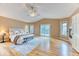 Sunlit main bedroom boasting a vaulted ceiling, hardwood floors, a sliding glass door, and a fireplace at 16458 W Ellsworth Dr, Golden, CO 80401
