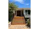 Inviting front entrance featuring a wooden door and a series of wooden steps at 6943 Fox Cir, Larkspur, CO 80118