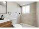 Modern bathroom featuring a tiled shower, sleek fixtures, and bright lighting at 14544 March Dr, Denver, CO 80239
