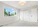 Bright bedroom featuring large window, closet and neutral carpet at 14544 March Dr, Denver, CO 80239
