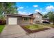 Well-maintained home with neat landscaping, gray brick and a two-car garage at 14544 March Dr, Denver, CO 80239