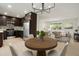 Bright open-concept kitchen and dining area with stainless steel appliances and modern chandelier at 14544 March Dr, Denver, CO 80239