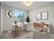 Bright home office featuring a large window, modern decor, and comfortable seating at 14544 March Dr, Denver, CO 80239