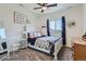 Sunny bedroom with ample natural light, a charming desk area, and a cozy bed with patterned bedding at 14881 Rider Pl, Parker, CO 80134