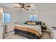 Cozy bedroom is filled with natural light and features a ceiling fan and neutral decor at 14881 Rider Pl, Parker, CO 80134