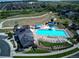 Aerial shot of the community pool and clubhouse, surrounded by manicured lawns and walking trails at 14881 Rider Pl, Parker, CO 80134